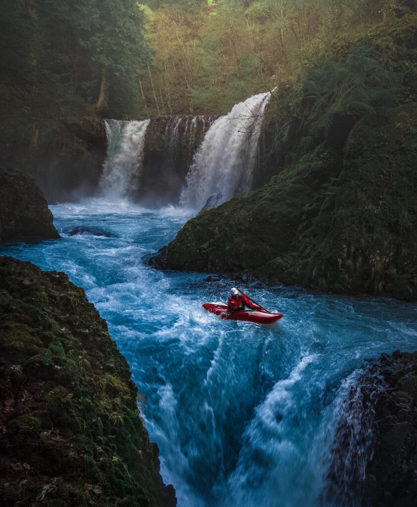 person on watercraft near waterfall 1761282